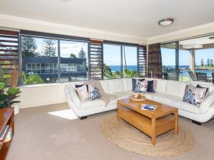 a living room with a white couch and a coffee table at Apartment 602 Sebel Kiama in Kiama