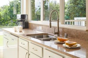 a kitchen counter with a sink and a window at The Cliffs at Princeville in Princeville