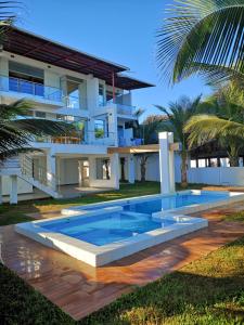 a swimming pool in front of a house at Casa de Mateo - Zorritos - Tumbes in Zorritos