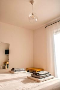 a bedroom with a bed with towels on it at Magna Grecia B&B e Appartamenti in Caulonia Marina