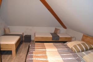 a attic room with two beds and a mattress at Gästehaus Klein in Hilders