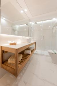 a white bathroom with a sink and a shower at Toboso Apar - Turis in Nerja