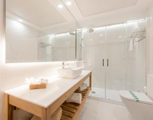 a white bathroom with a sink and a shower at Toboso Apar - Turis in Nerja