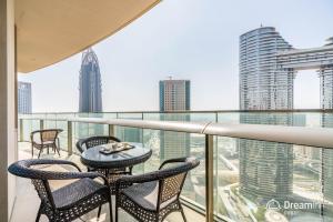 a balcony with two chairs and a table at Dream Inn Dubai Apartments- Burj Vista in Dubai