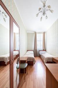 a hospital room with two beds and a mirror at RA Kuznechny 19 in Saint Petersburg