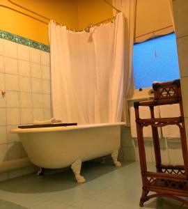 La salle de bains est pourvue d'une baignoire blanche et d'une douche. dans l'établissement Langley Estate, Bendigo, à Bendigo