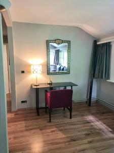 a room with a desk and a chair and a mirror at Le Manoir De Morimont in Céroux-Mousty