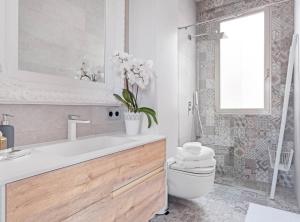 a bathroom with a sink and a toilet and a mirror at ALCALA III in Madrid