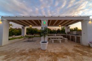 un patio con una mesa y una maceta en Casale del Gelso, en Monopoli