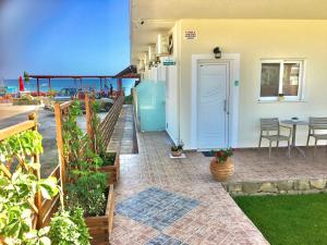 a house with a patio with a table and chairs at Emmanouela's Apts in Kissamos