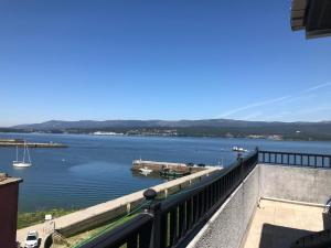 a view of a body of water from a balcony at Hostal O Portiño in Rianjo