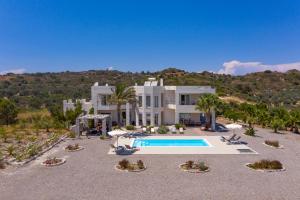 ein großes weißes Haus mit einem Pool in der Unterkunft Andrealexia Sea View Villa in Kalithies