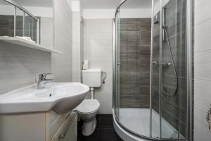 a bathroom with a toilet and a sink and a shower at Apartments Dante in Umag +38 photos