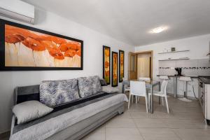 a living room with a couch and a table at Apartments Dante in Umag