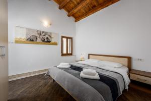 a bedroom with a large bed with towels on it at Apartments Dante in Umag