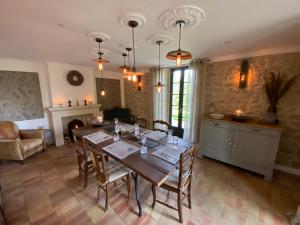 a kitchen and dining room with a table and chairs at Maison Mûrier in Fayssac