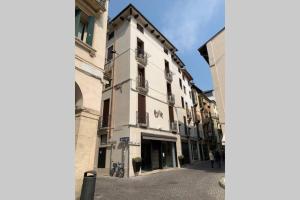 a tall white building on the side of a street at Casa Palladio S in Vicenza