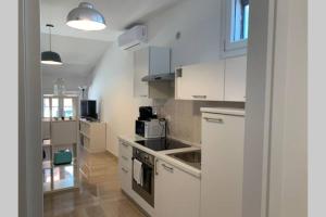 a kitchen with white cabinets and a sink at Casa Palladio S in Vicenza