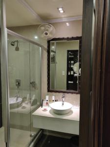 a bathroom with two sinks and a shower at Mayfair Convention in Bhubaneshwar