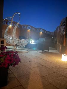a patio with chairs and lights at night at Apartamenty Blisko Centrum in Toruń