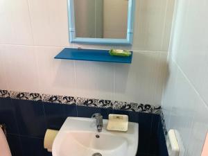 a bathroom with a sink and a mirror at Avrora L in Zatoka +9 photos