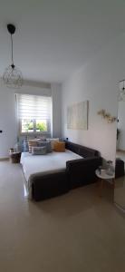 a bedroom with a large bed and a couch at L’angolo d’aMare in Lerici