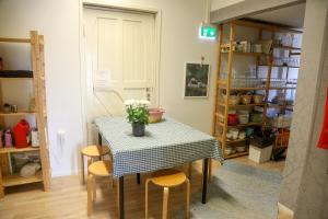 a table with chairs and a vase of flowers on it at Wanhan Aseman Majatalo in Savonlinna