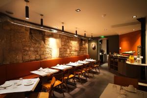 a restaurant with tables and chairs in a room at Chateaudun Opéra in Paris