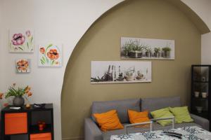 a living room with a couch and some potted plants at Casetta Bevilacqua in Sciacca