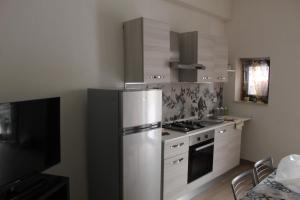 a kitchen with a stainless steel refrigerator and a stove at Casetta Bevilacqua in Sciacca