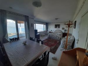 a living room with a table and a couch at Manzaraada Tepe in Heybeliada