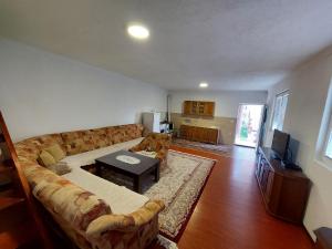 a living room with a couch and a table at Sara Apartments Plav in Plav