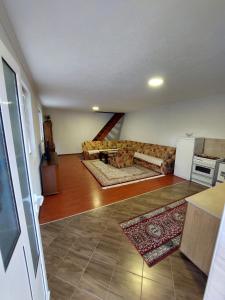 a living room with a couch and a kitchen at Sara Apartments Plav in Plav