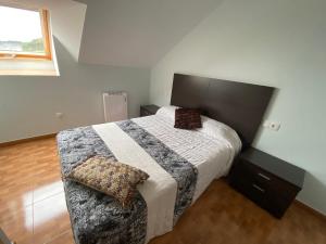 a bedroom with a large bed and a window at Las Catedrales in Barreiros +14 photos