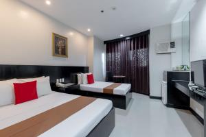 En eller flere senger på et rom på Check Inn Hotel Dumaguete City by RedDoorz