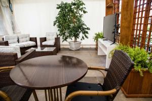 a table and chairs in a living room with a tv at Hotel La Tavernetta dei Ronchi in Marina di Massa