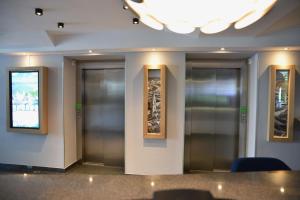 a row of elevators in a building at Holiday Inn - Salzburg City, an IHG Hotel in Salzburg