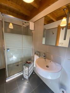 a bathroom with a sink and a shower at Apartamentos Los Molinos in Llanes +65 photos