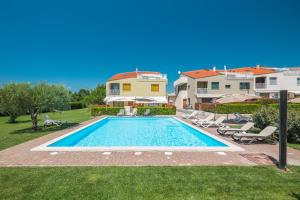 a swimming pool in the backyard of a house at Maj Premium Residence in Poreč