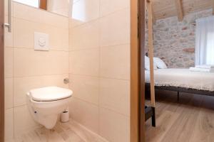 a bathroom with a toilet and a bunk bed at Casa Rustivéra - Island Hvar in Vrbanj +43 photos