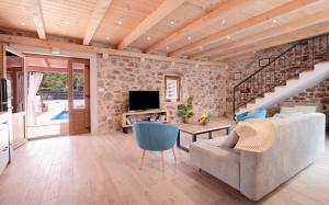 a living room with a couch and a table at Luxury Rustic Villa Hvar island in Vrbanj