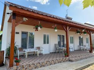 a house with a wooden roof and a patio at Houses by the sea in Vadu