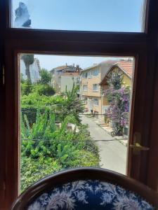 a window with a view of a street and buildings at Manzaraada Merkez in Heybeliada