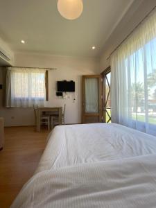 a bedroom with a large white bed and a table at The Mansion El Gouna in Hurghada