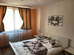 a bedroom with a bed with a blanket on it at Vibe studio in Piatra Neamţ