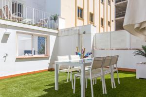 a dining room with a table and chairs on grass at iloftmalaga Ricardo Soriano in Marbella