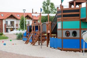 a playground with a slide in the sand at Łebska Ostoja - AKS in Żarnowska