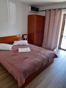 a bedroom with a large bed with a red blanket at Casa Zoe Seaca in Călimăneşti