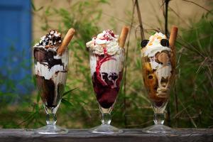 three ice cream sundas sitting on a table at Vert Lodge Chamonix in Chamonix-Mont-Blanc
