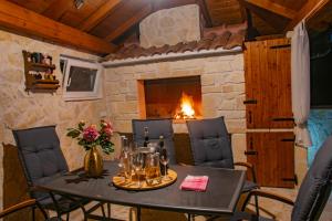a dining room with a table and a fireplace at Villa Mara in Drniš